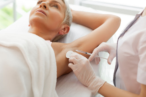 Woman receiving botox injections in her underarms